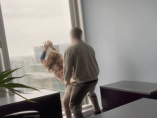 MILF boss fucked against her meeting pane